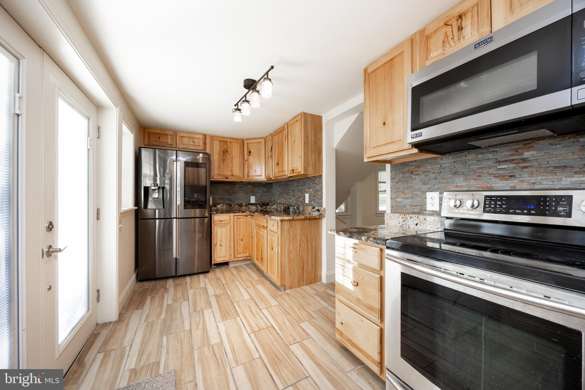 103 Valley View Road Phoenixville, PA 19460 - Photo 10 of 38 a kitchen with a stove a sink and a microwave