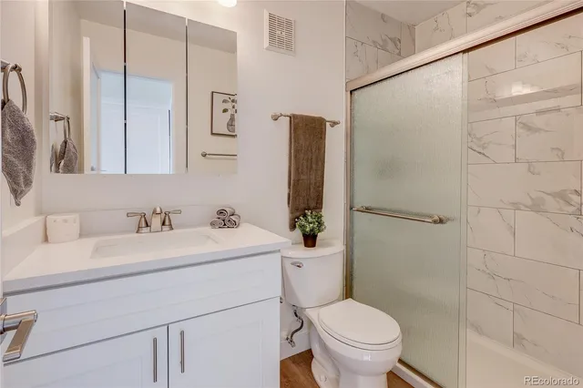 a bathroom with a sink toilet and shower
