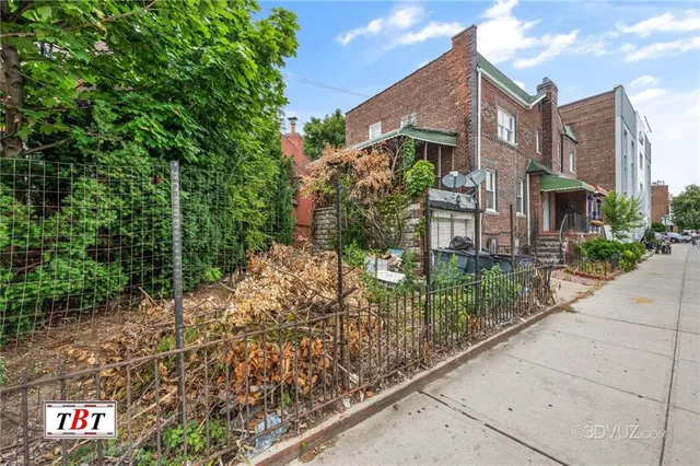 a view of a street with potted plants