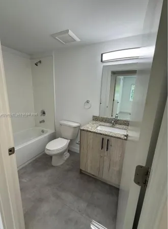 a bathroom with a sink a toilet and a bathtub
