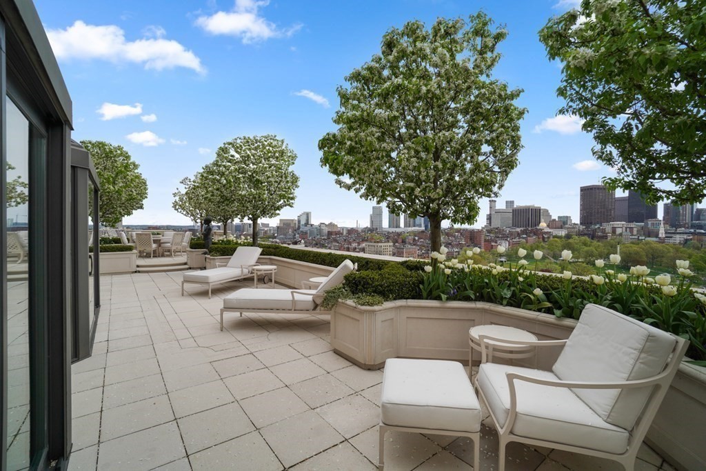 2 Commonwealth Avenue, Unit PH2 & 16E Boston, MA 02116 - Photo 11 of 24 a view of a patio with a table and chairs