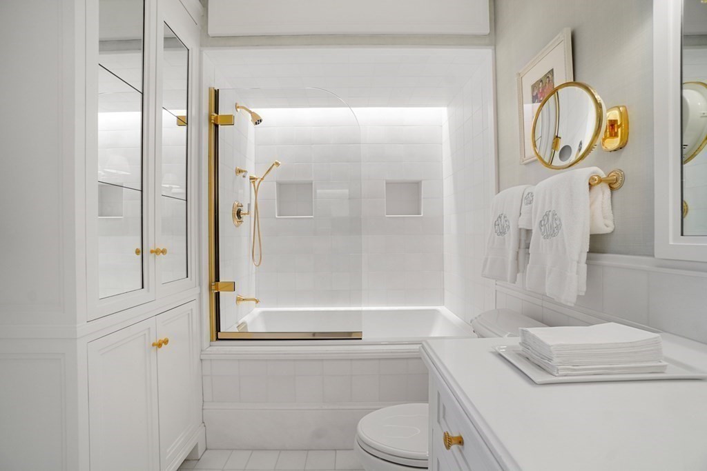 2 Commonwealth Avenue, Unit PH2 & 16E Boston, MA 02116 - Photo 20 of 24 a bathroom with a granite countertop bathtub shower sink vanity and toilet