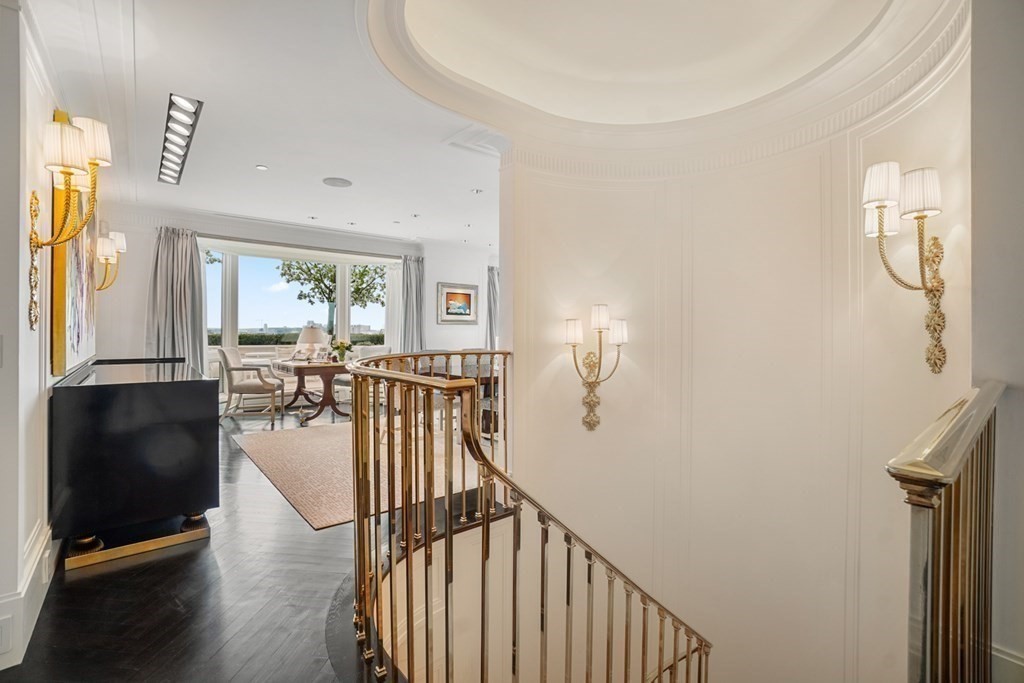 2 Commonwealth Avenue, Unit PH2 & 16E Boston, MA 02116 - Photo 21 of 24 a view of a hallway with wooden floor and windows