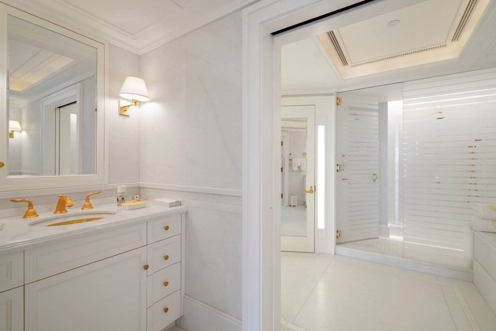2 Commonwealth Avenue, Unit PH2 & 16E Boston, MA 02116 - Photo 23 of 24 a bathroom with a sink and a mirror