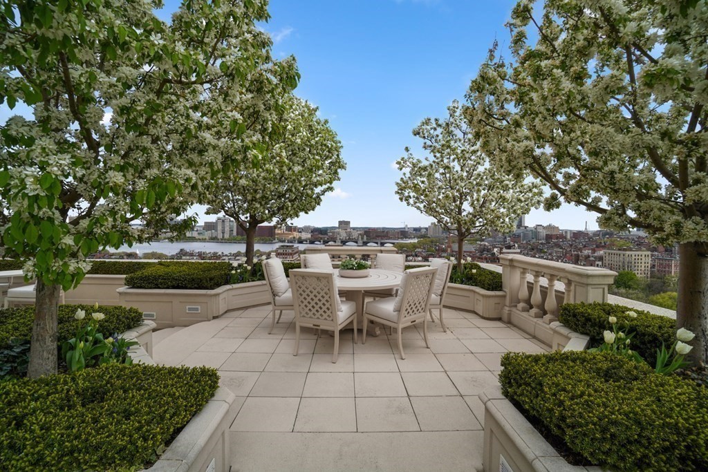 2 Commonwealth Avenue, Unit PH2 & 16E Boston, MA 02116 - Photo 10 of 24 a view of a patio with table and chairs potted plants and a large tree