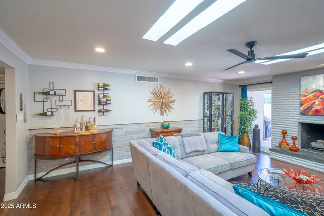 a living room with furniture fireplace and flat screen tv