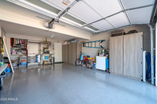 a view of a house with a big yard and palm trees