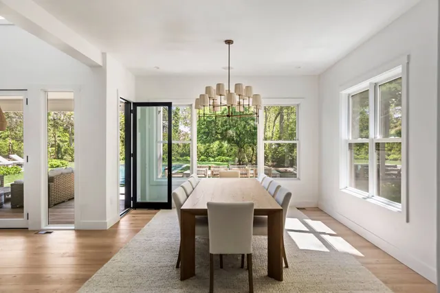 a dining room with furniture window and wooden floor