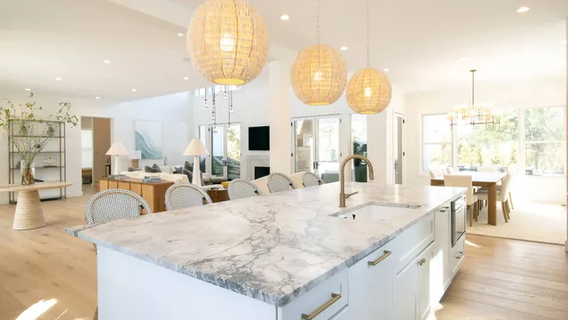 a large kitchen with kitchen island granite countertop a large counter and a sink