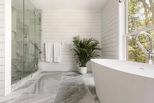 a white bath tub sitting in front of a window