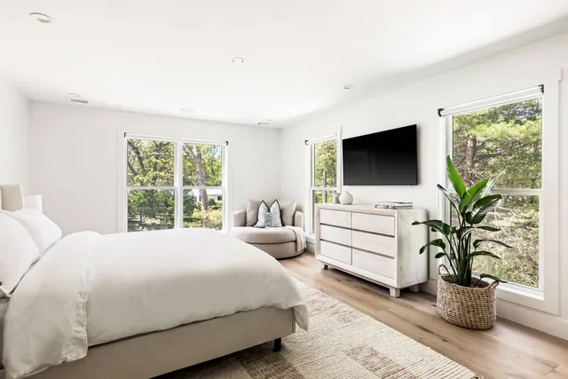 a bedroom with a bed and a flat screen tv