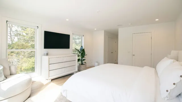 a bedroom with a bed and a flat screen tv