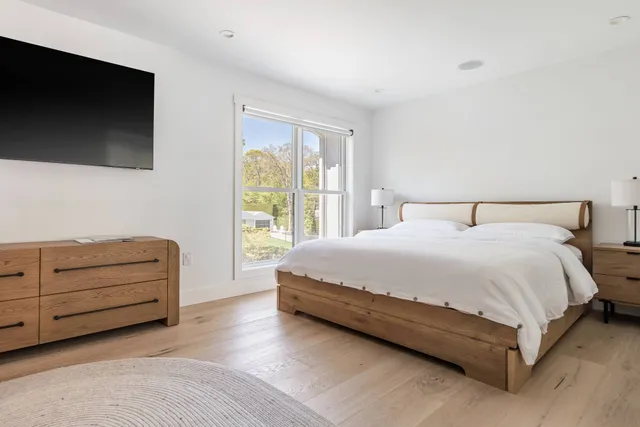 a bedroom with a bed and a flat screen tv