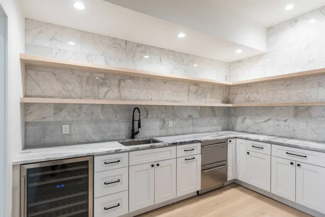 a kitchen with a sink dishwasher and cabinets