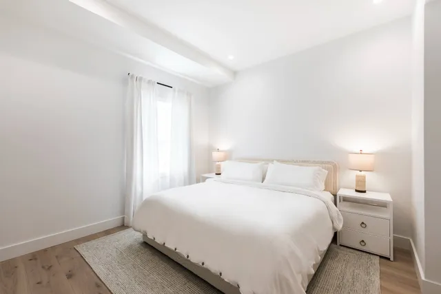 a bedroom with a bed and a night stand