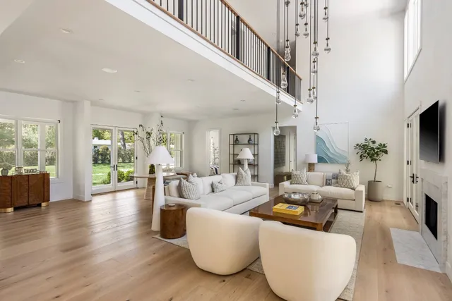 a living room with fireplace furniture and a flat screen tv