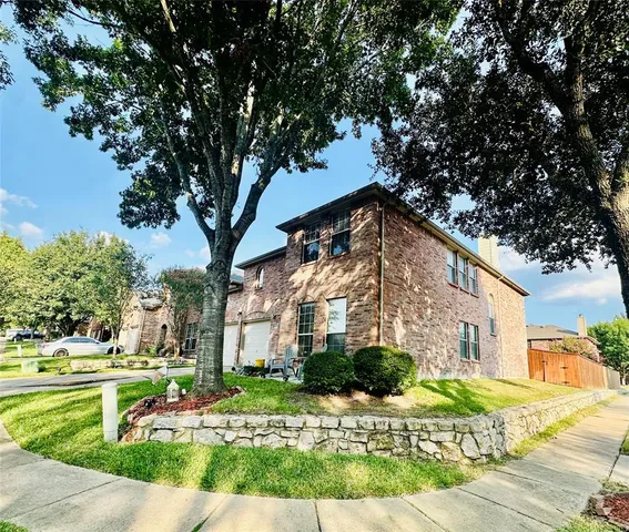 a view of a large building with large trees