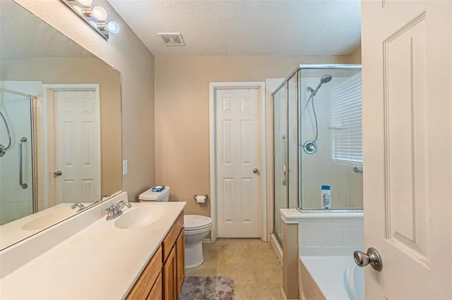 a bathroom with a sink and mirror with toilet