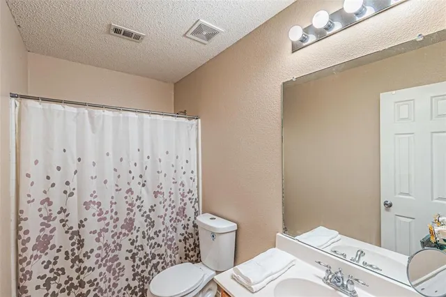 a view of a backyard with wooden fence