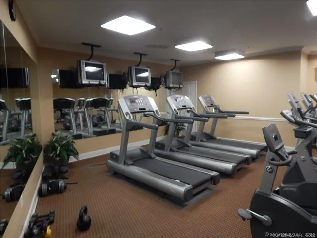 a gym room with lots of gym equipment