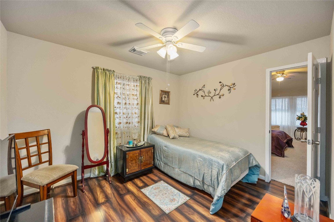 3022 Pathfinders Pass Spring, TX 77373 - Photo 14 of 24 a bedroom with a bed and a chandelier