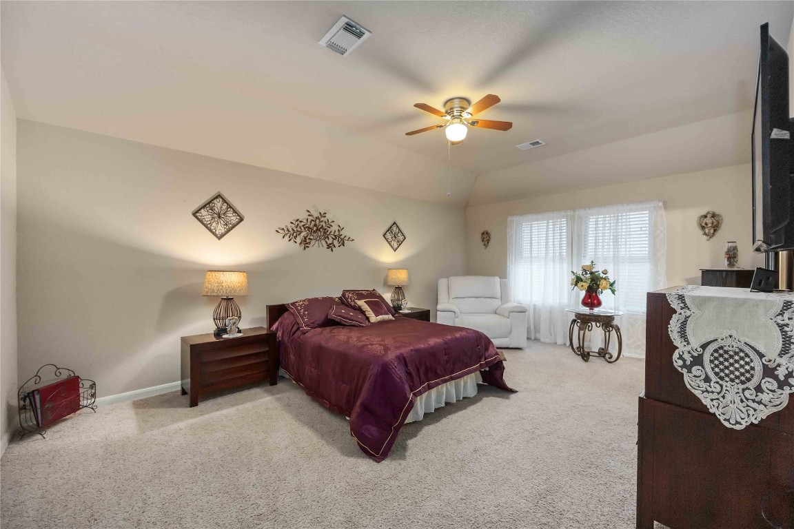 3022 Pathfinders Pass Spring, TX 77373 - Photo 17 of 24 a bedroom with a bed and a chandelier