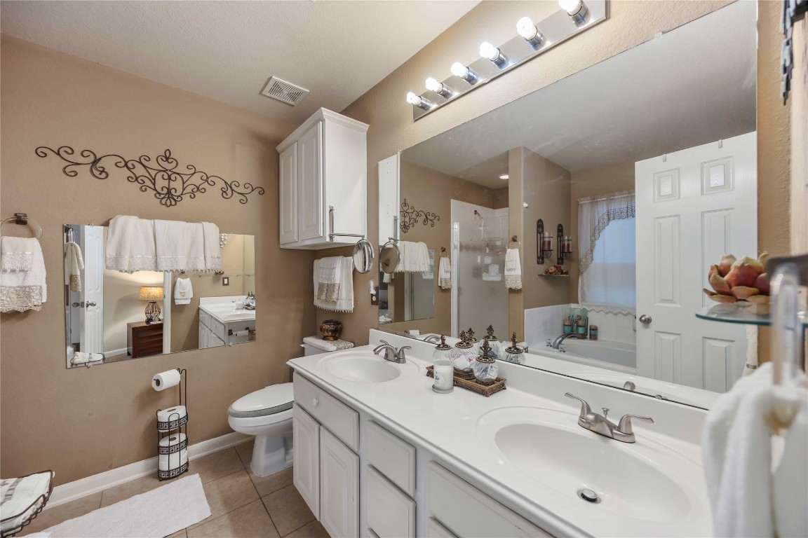 3022 Pathfinders Pass Spring, TX 77373 - Photo 19 of 24 a bathroom with a double vanity sink mirror and toilet