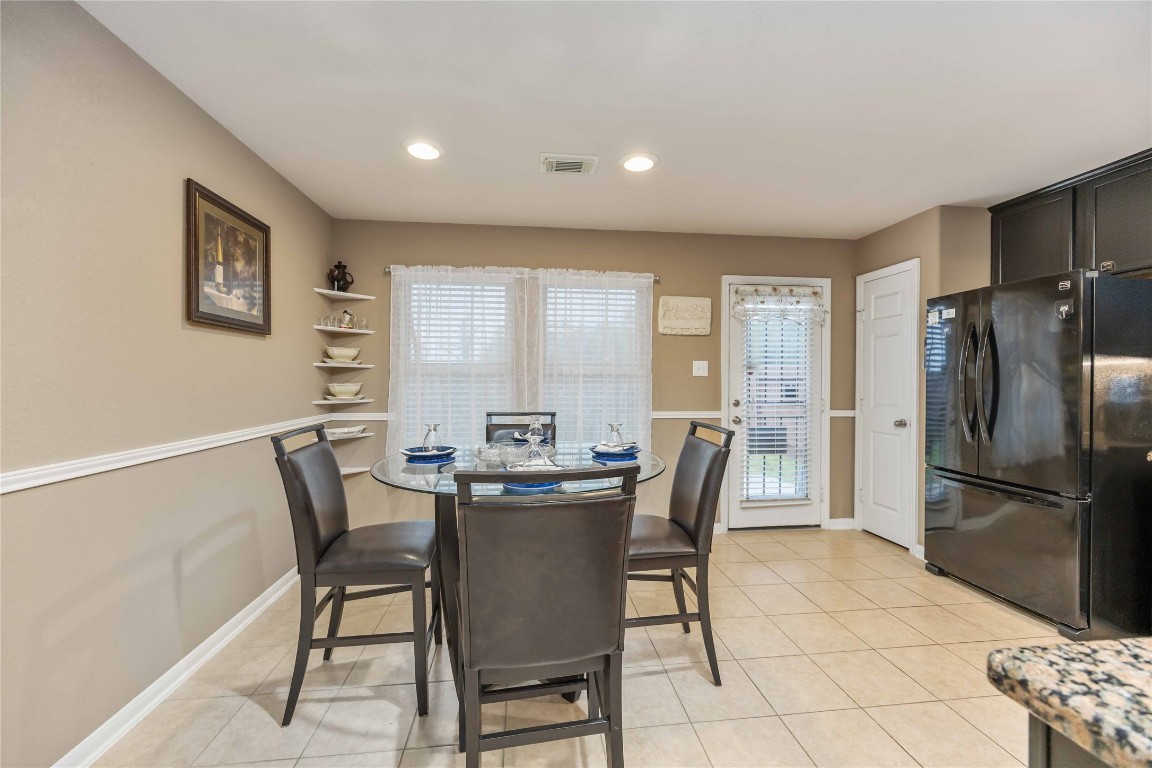 3022 Pathfinders Pass Spring, TX 77373 - Photo 3 of 24 a view of a dining room with furniture and a refrigerator