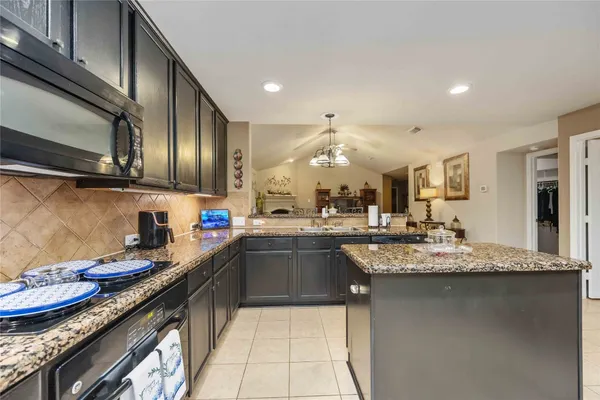 a kitchen with granite countertop stainless steel appliances and sink