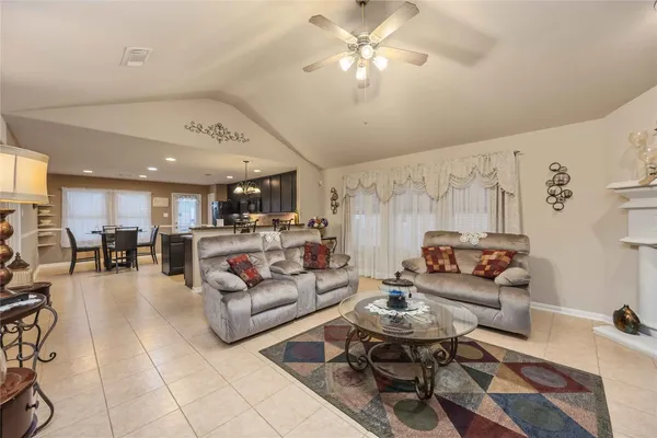 a living room with furniture and kitchen view
