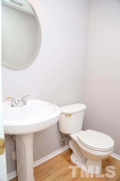 8312 Chimneycap Drive Raleigh, NC 27613 - Photo 11 of 25 a white toilet sitting next to a bathroom sink