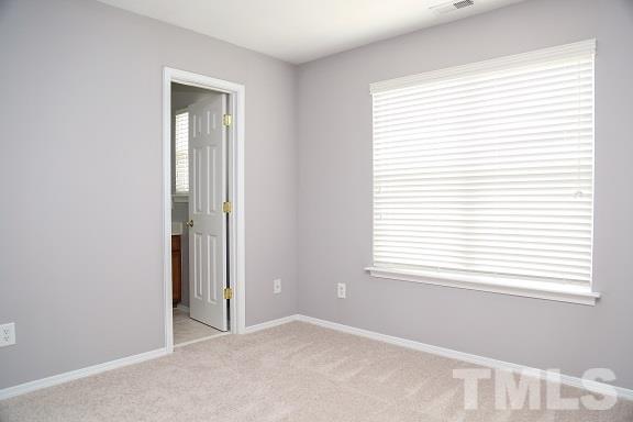 8312 Chimneycap Drive Raleigh, NC 27613 - Photo 16 of 25 a view of an empty room with a window