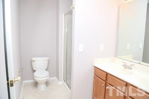 8312 Chimneycap Drive Raleigh, NC 27613 - Photo 18 of 25 a bathroom with a toilet sink and mirror