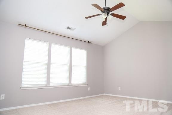 8312 Chimneycap Drive Raleigh, NC 27613 - Photo 20 of 25 an empty room with window and a ceiling fan