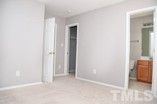 8312 Chimneycap Drive Raleigh, NC 27613 - Photo 21 of 25 an empty room with closet and mirror