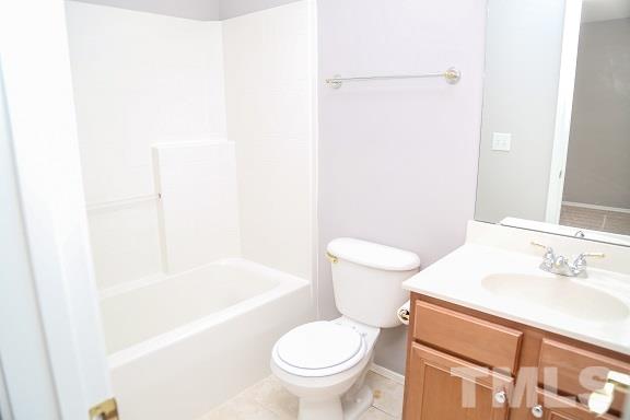 8312 Chimneycap Drive Raleigh, NC 27613 - Photo 22 of 25 a bathroom with a sink a toilet and a bathtub