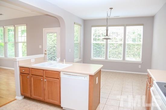 8312 Chimneycap Drive Raleigh, NC 27613 - Photo 8 of 25 a kitchen with a sink and large window