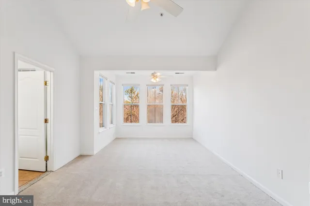 an empty room with windows and entrance