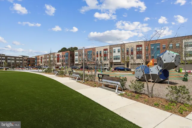a view of a house with a big yard and sitting area