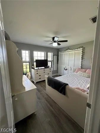 a large bedroom with a bed and a view of living room