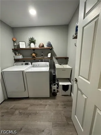 a room with gym equipment and wooden floor