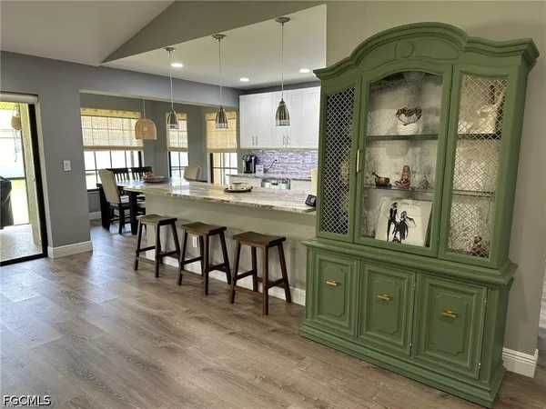 a view of a dining room kitchen with furniture and wooden floor