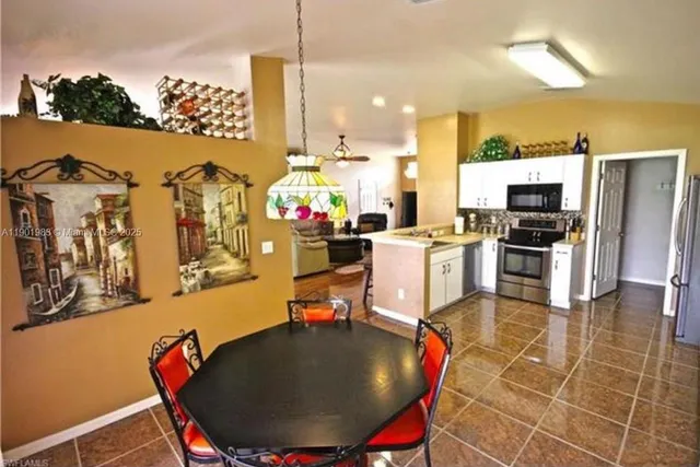 a kitchen with stainless steel appliances kitchen island granite countertop a sink and cabinets