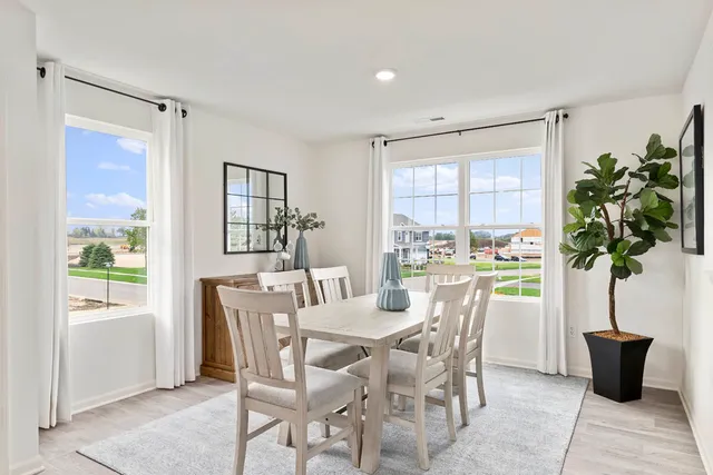 a dining room with furniture and window