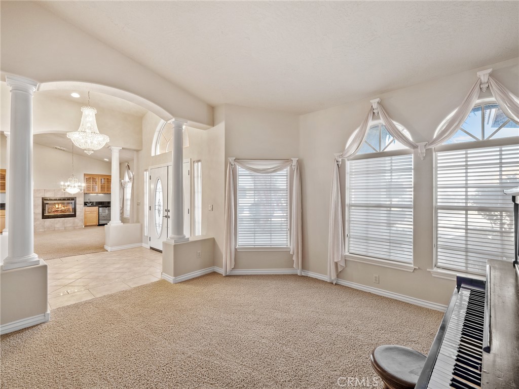 11385 Oak Ridge Drive Oak Hills, CA 92344 - Photo 29 of 69 a view of an empty room with a fireplace and a large window