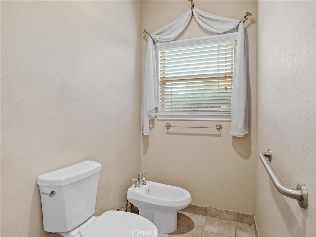 11385 Oak Ridge Drive Oak Hills, CA 92344 - Photo 47 of 69 a bathroom with a toilet and a sink