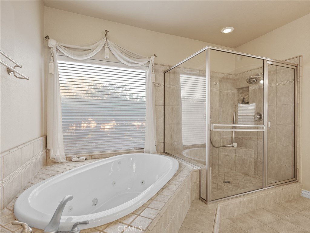 11385 Oak Ridge Drive Oak Hills, CA 92344 - Photo 51 of 69 a bathroom with a bathtub and a shower