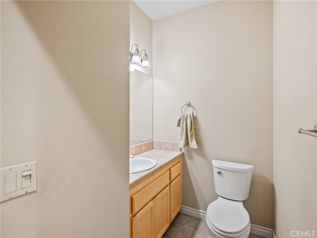 11385 Oak Ridge Drive Oak Hills, CA 92344 - Photo 62 of 69 a bathroom with a toilet sink and mirror