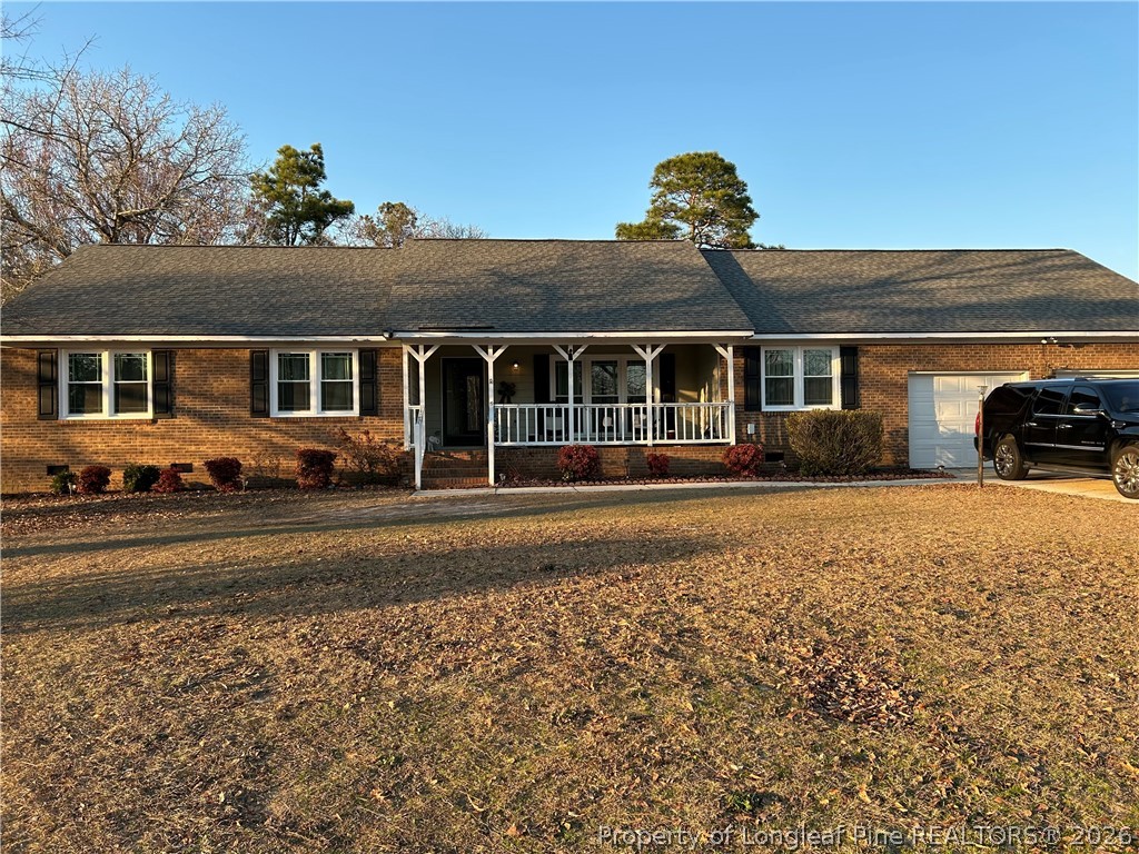 6520 Bagdad Road Fayetteville, NC 28306 - Photo 2 of 6 front view of a house with a yard
