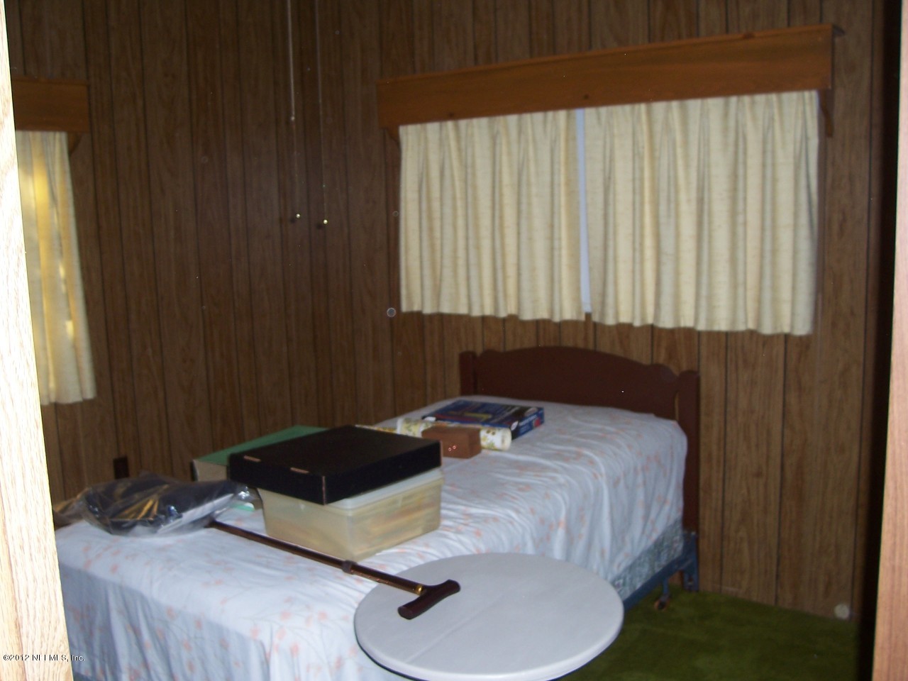 6254 Payne Road Keystone Heights, FL 32656 - Photo 8 of 17 a bed sitting in a bedroom next to a window